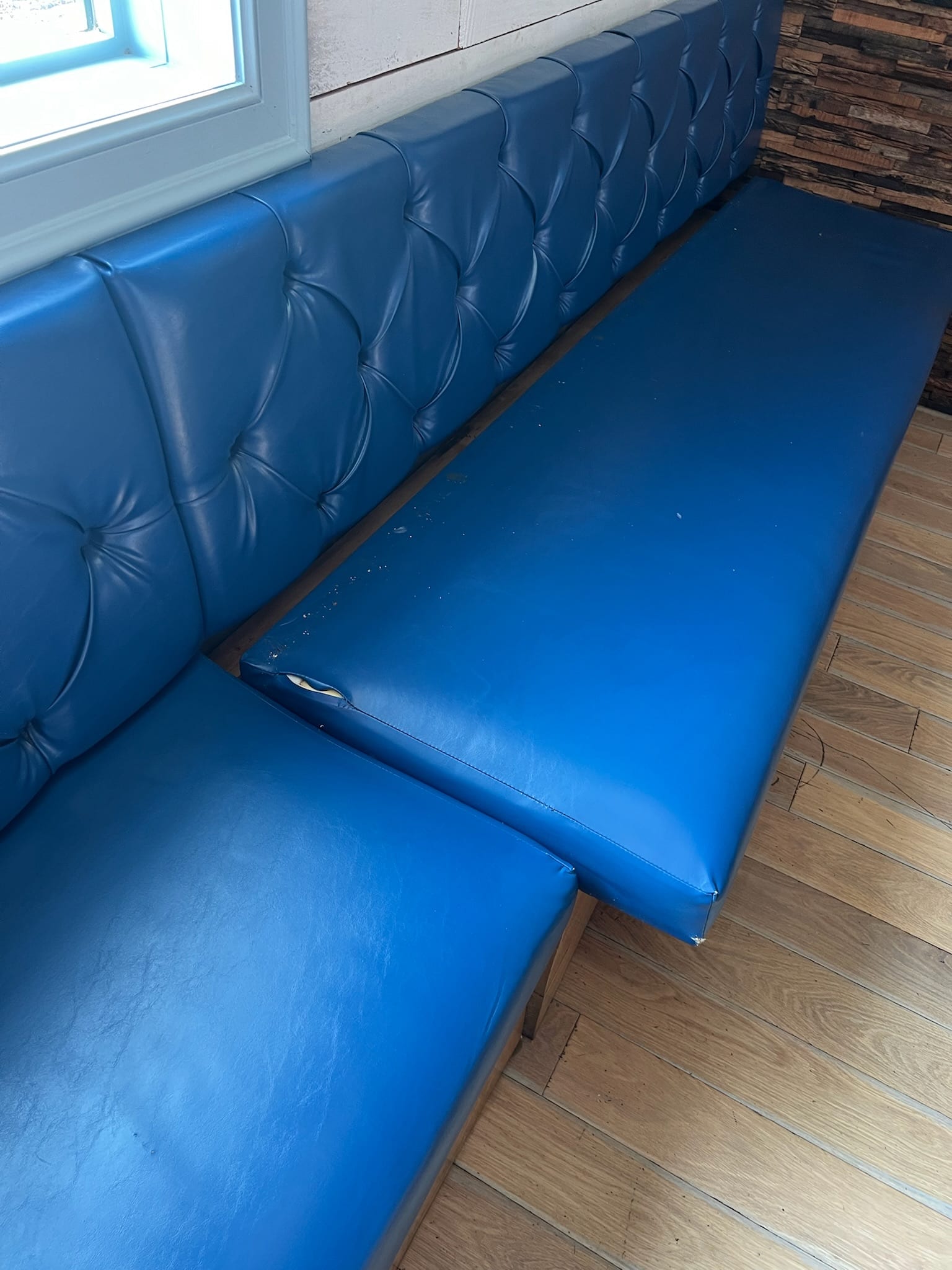 Reupholstered blue diamond-stitch restaurant booth