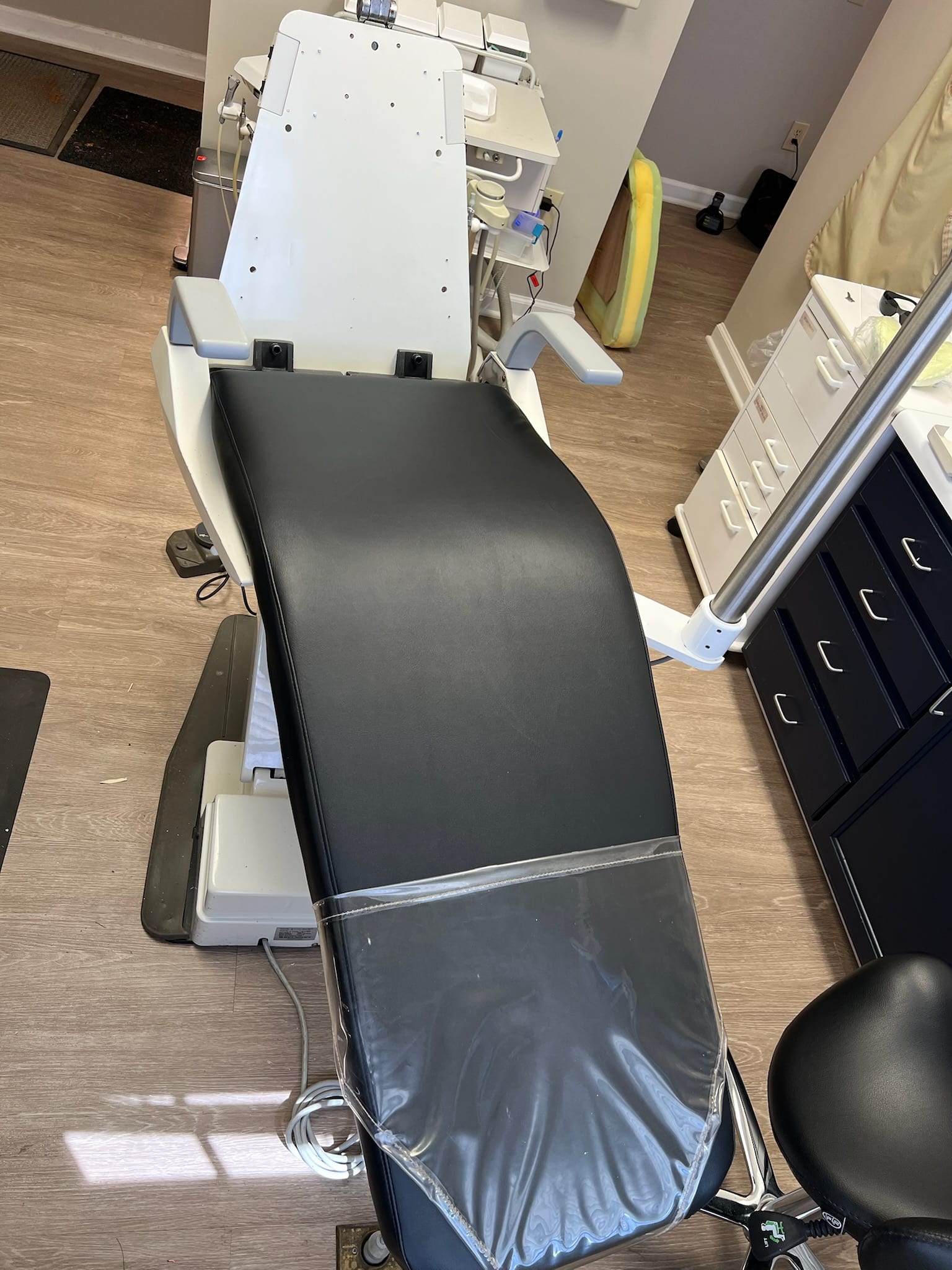 Black exam chair reupholstered with new vinyl
