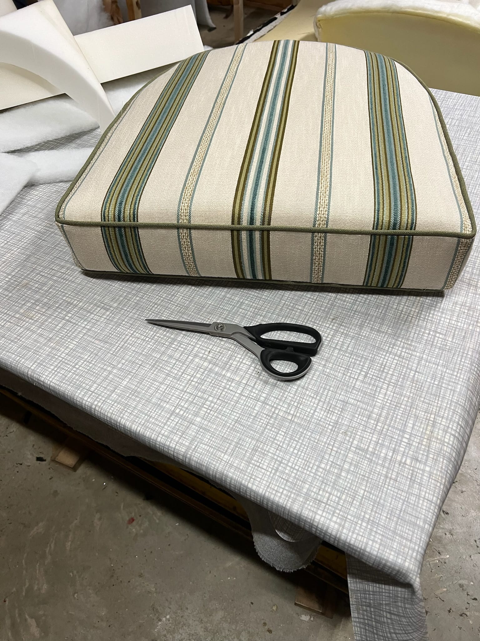 Striped marine cushion reupholstered in UV-stable vinyl