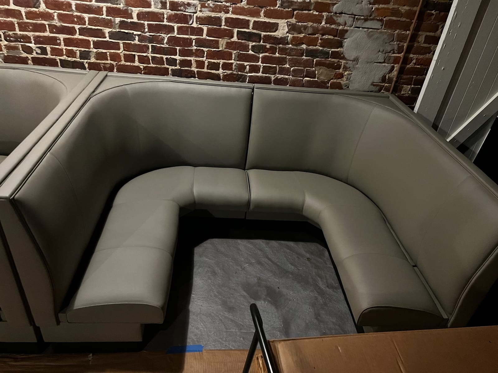 Olive green curved banquette reupholstered