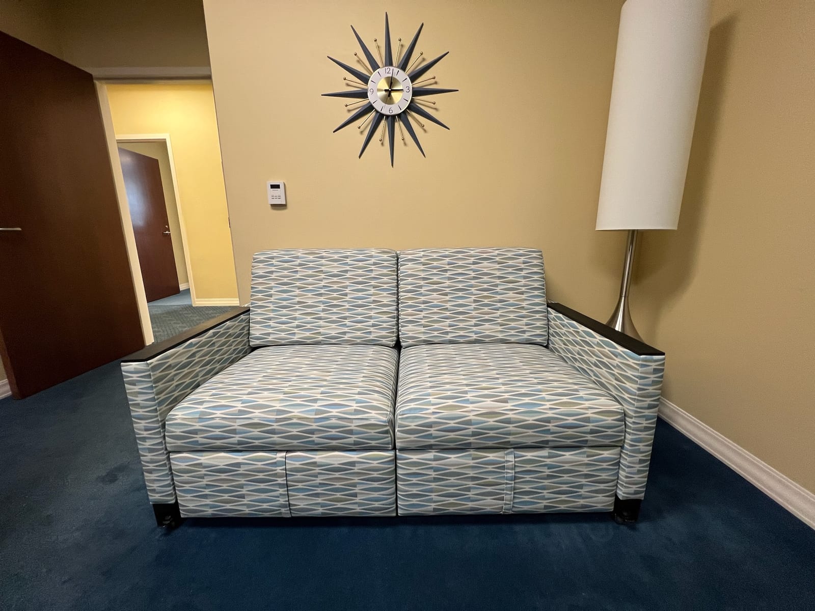 Patterned loveseat reupholstered in floral fabric