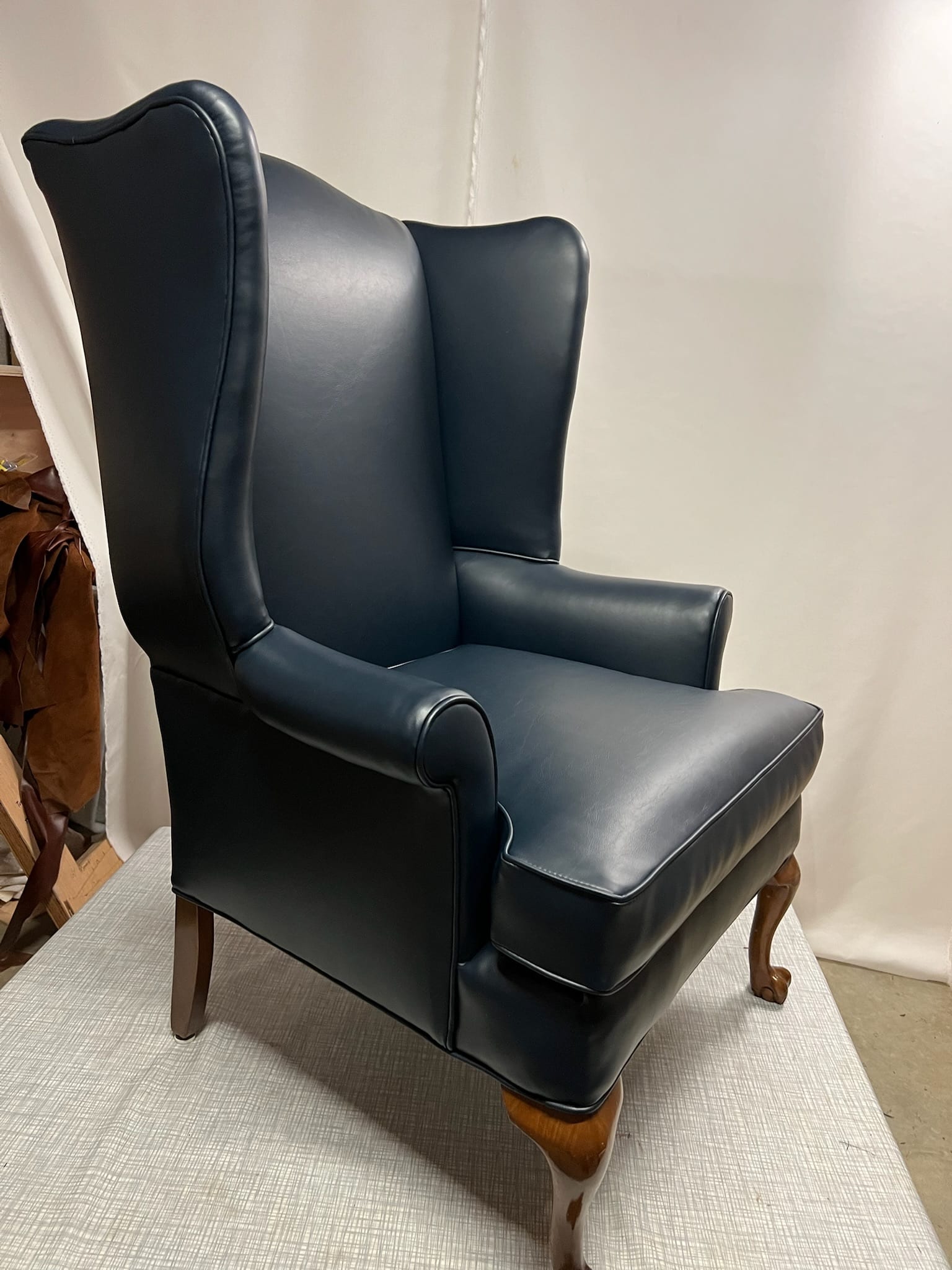Black wingback chair reupholstered in solid fabric