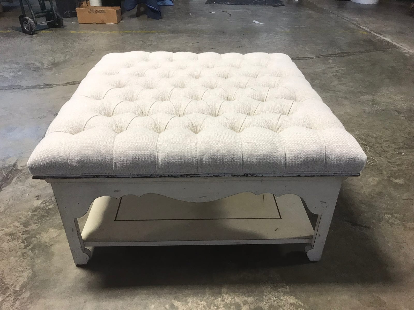 Sofa cushion casings being rebuilt on a workshop bench with new high-density foam